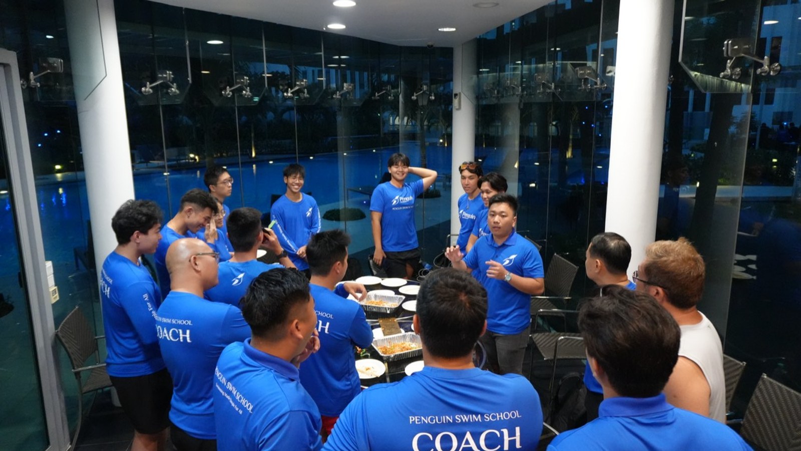 Penguin Swim School coach team gathered for coaching discussion in Singapore