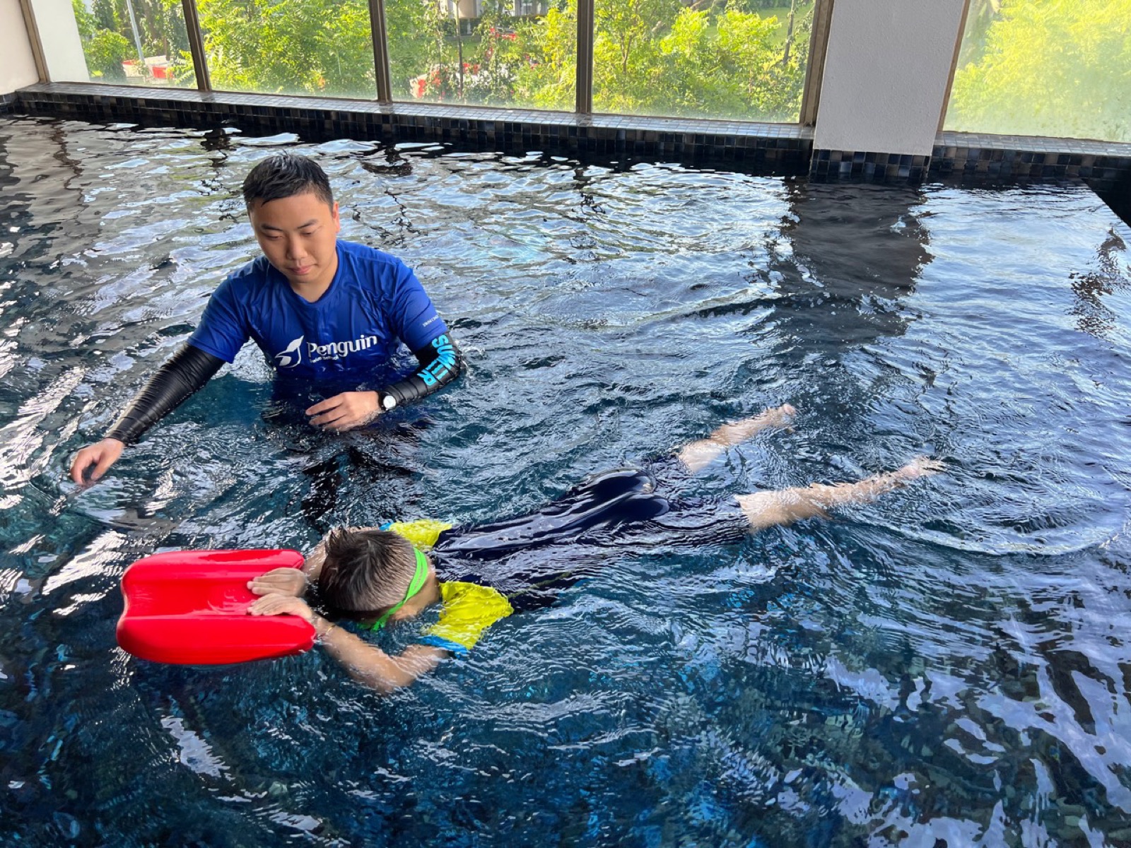 Penguin learner using swim training equipment